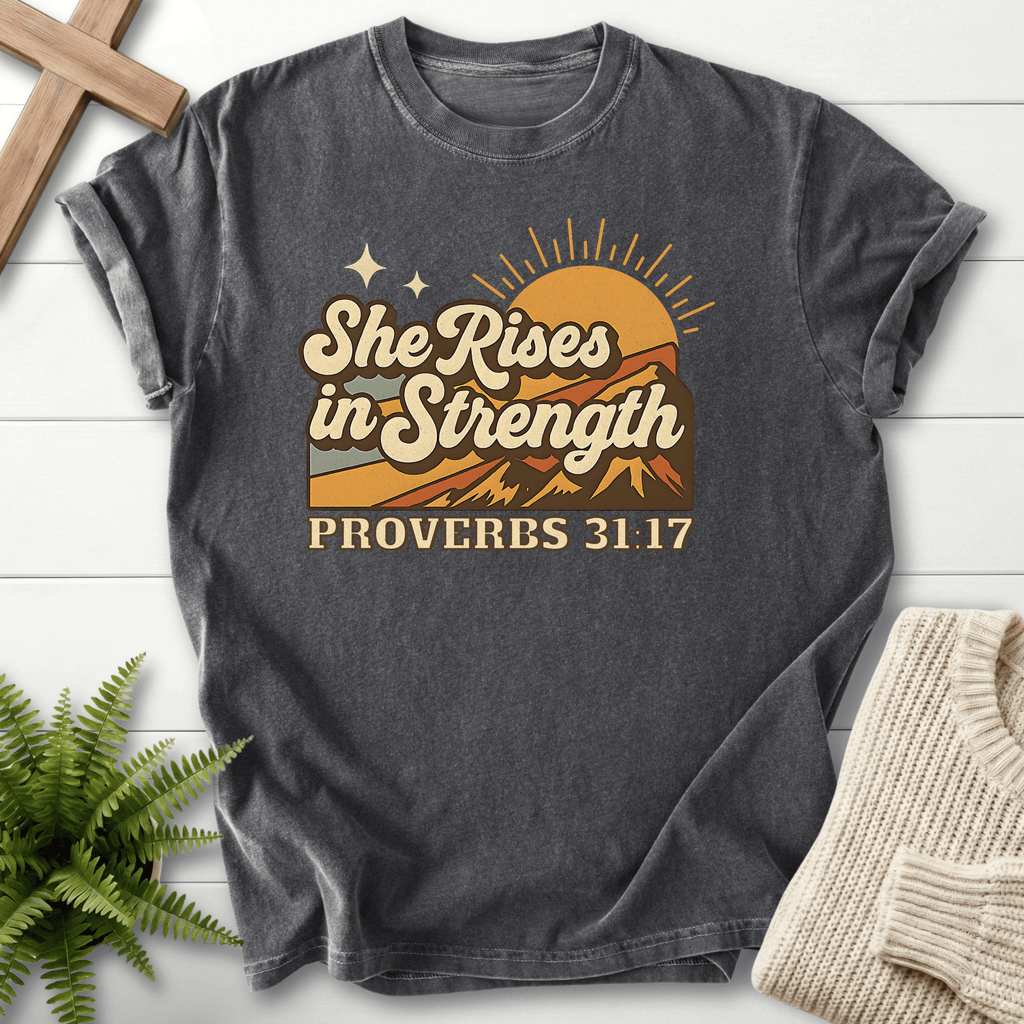 Pepper women's Christian t-shirt with vintage mountain sunrise and "She Rises in Strength," inspired by Proverbs 31:17.