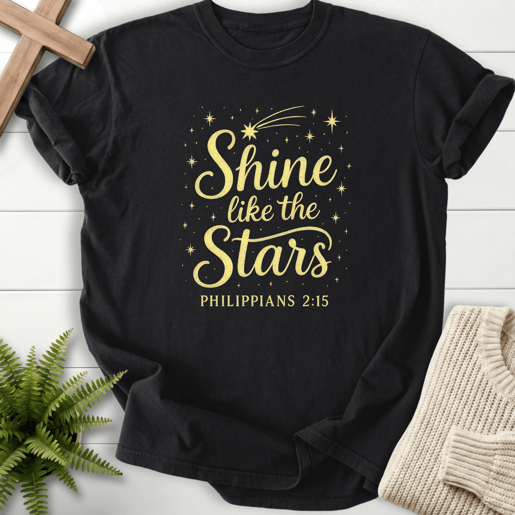 Black women's Christian t-shirt with gold "Shine like the Stars" script and shooting star, inspired by Philippians 2:15.
