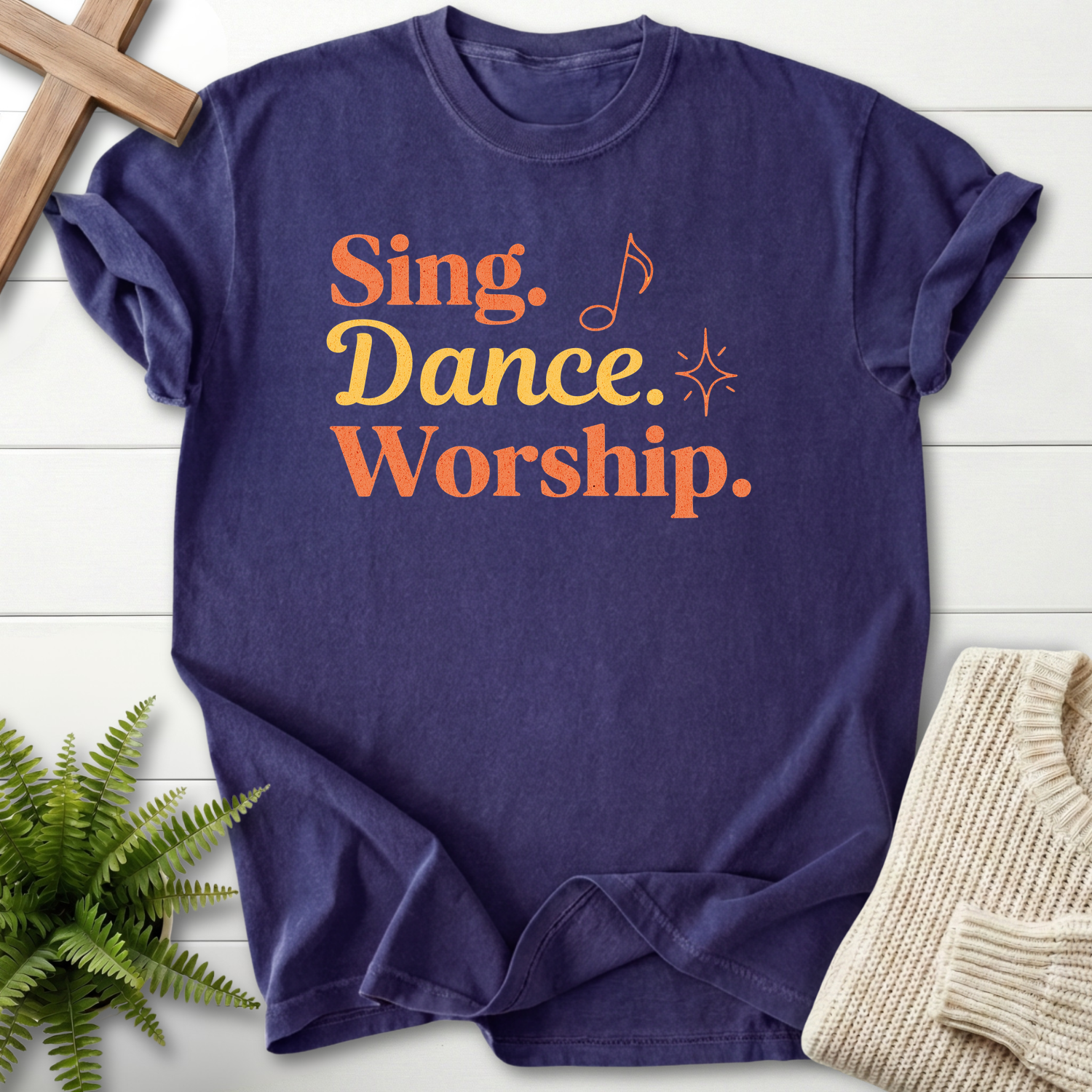Grape women's Christian t-shirt with retro "Sing, Dance, Worship" design in orange and gold.