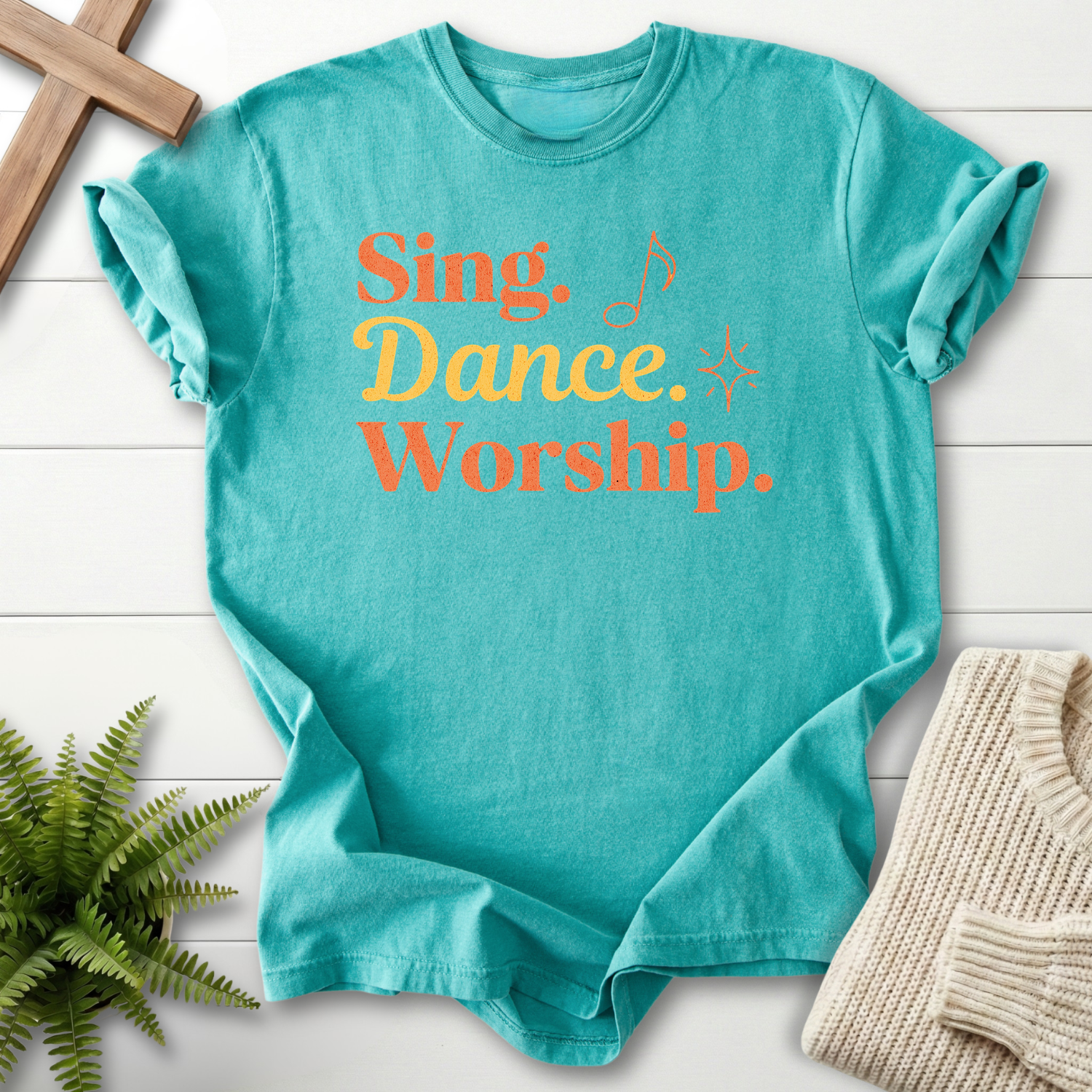 Seafoam women's Christian t-shirt with bold "Sing, Dance, Worship" retro lettering.