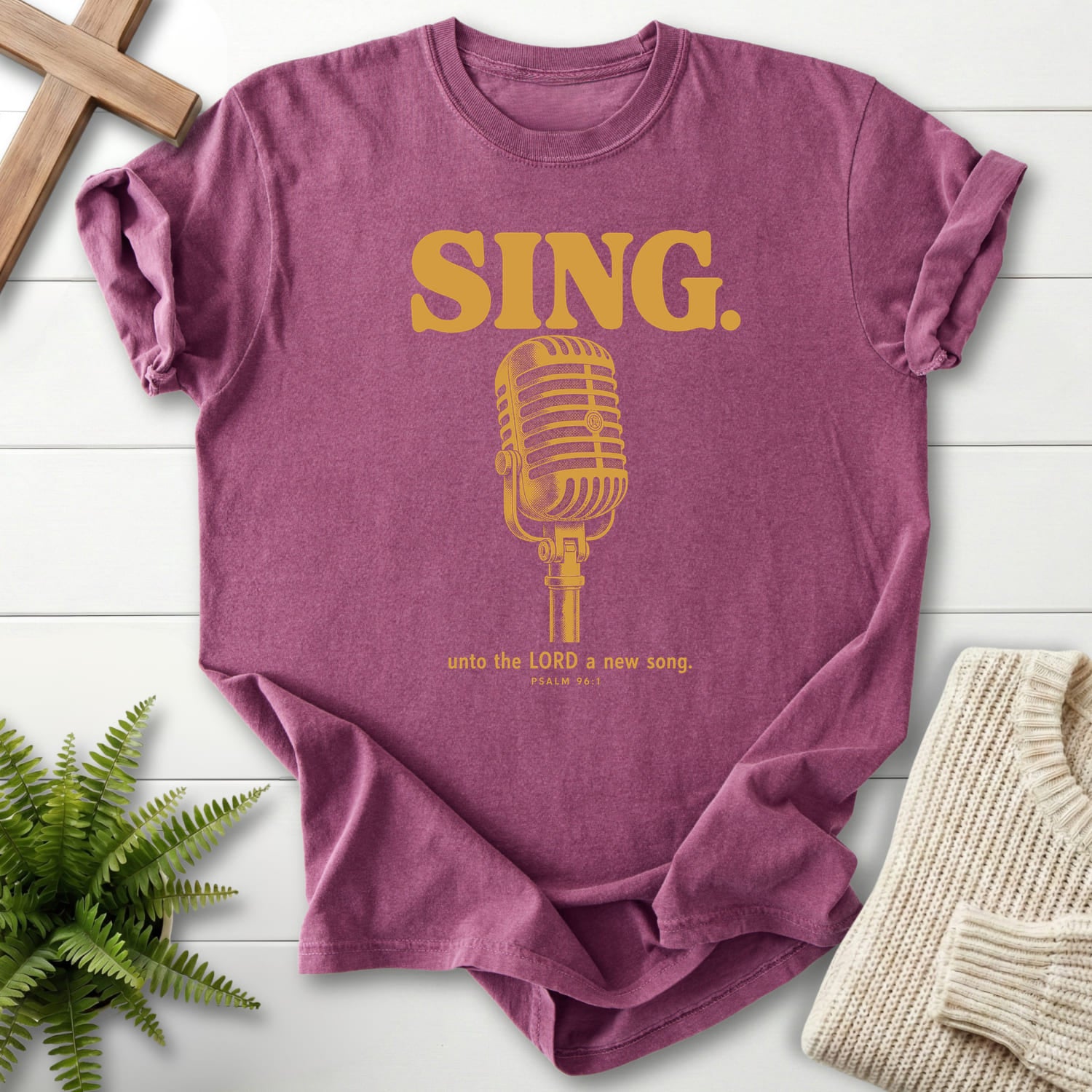 Flat lay of a Berry faith-inspired shirt featuring "Sing Unto the LORD Psalm 96 T-Shirt" Psalm 96:1.
