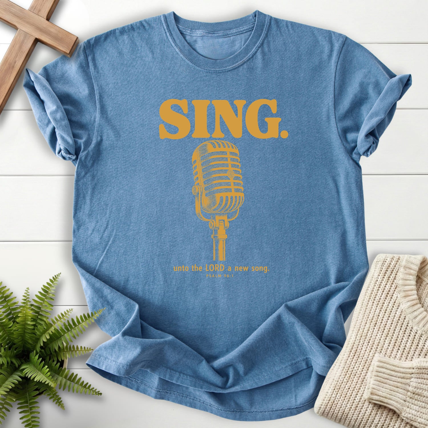 Flatlay of a Blue Jean Christian shirt with "Sing Unto the LORD Psalm 96 T-Shirt" Psalm 96:1.