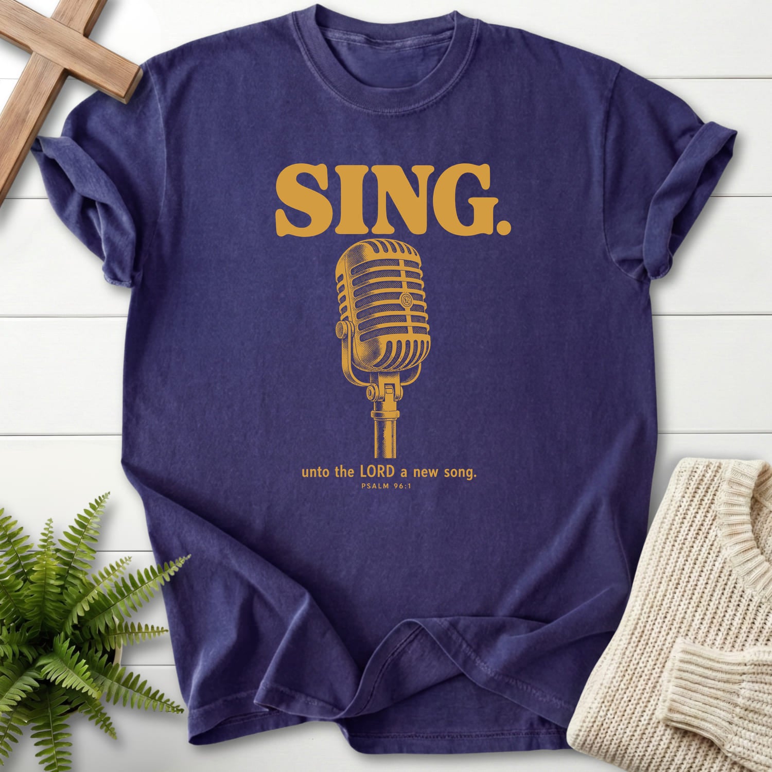 Flat lay of a Grape faith-based tee featuring "Sing Unto the LORD Psalm 96 T-Shirt" Psalm 96:1.