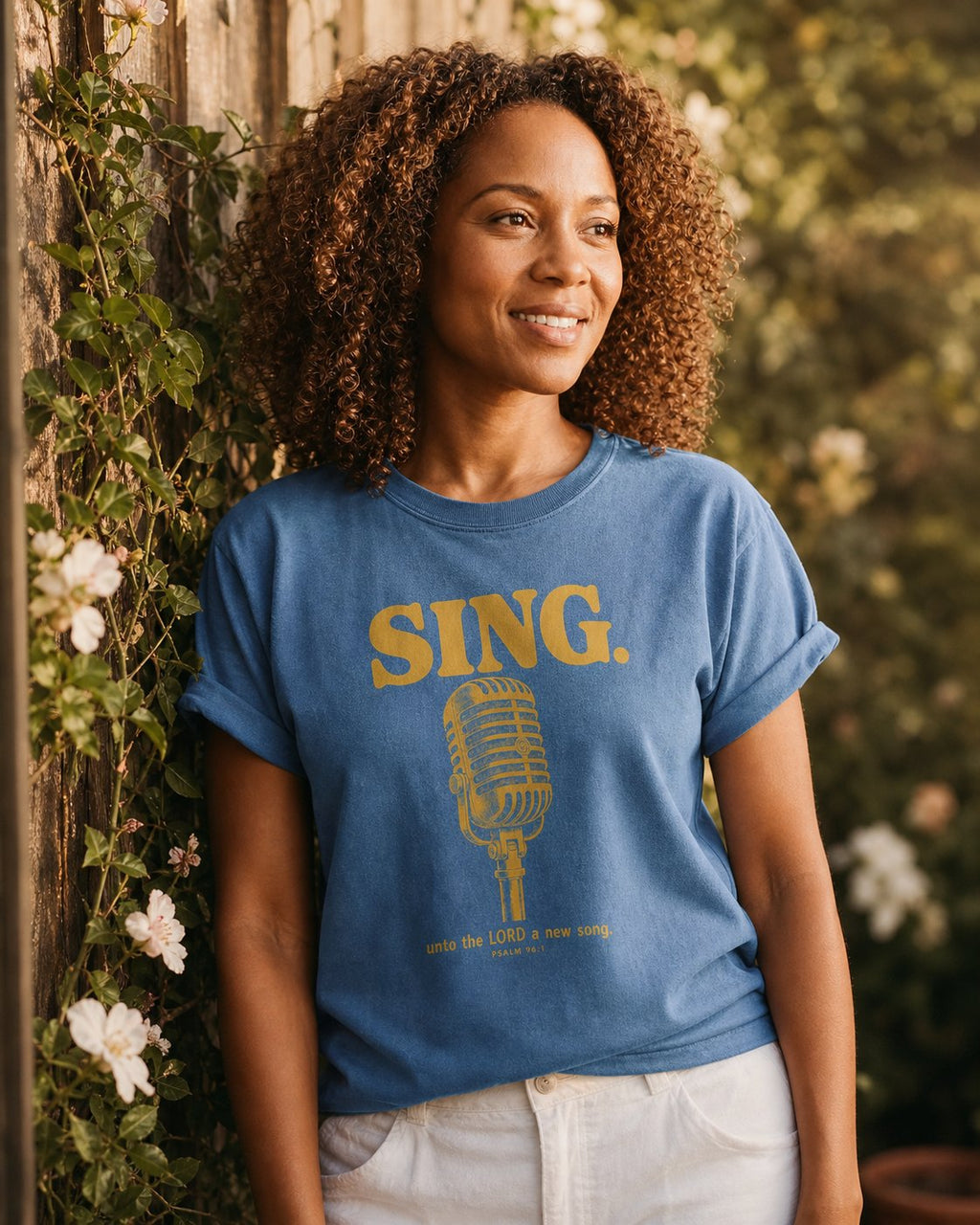 Sing Unto the LORD Psalm 96 – Blue Jean women's Christian tee, lifestyle photo in outdoor garden – Vintage microphone with bold SING lettering in golden ink – Psalm 96:1 – She Wears Faith