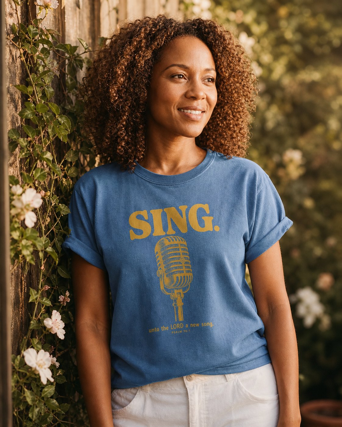 Sing Unto the LORD Psalm 96 – Blue Jean women's Christian tee, lifestyle photo in outdoor garden – Vintage microphone with bold SING lettering in golden ink – Psalm 96:1 – She Wears Faith