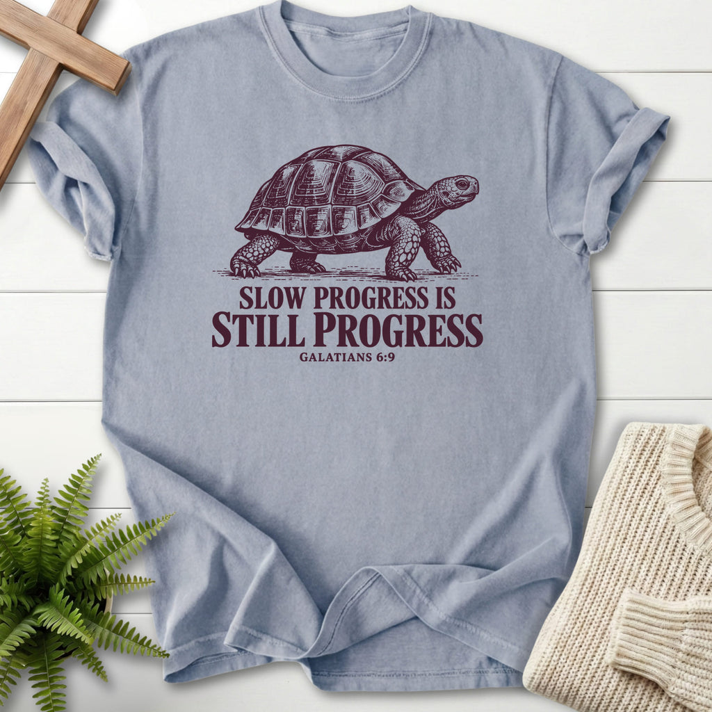 Flat lay of a Granite Christian graphic tee featuring "Slow Progress Is Still Progress T-Shirt" Galatians 6:9.