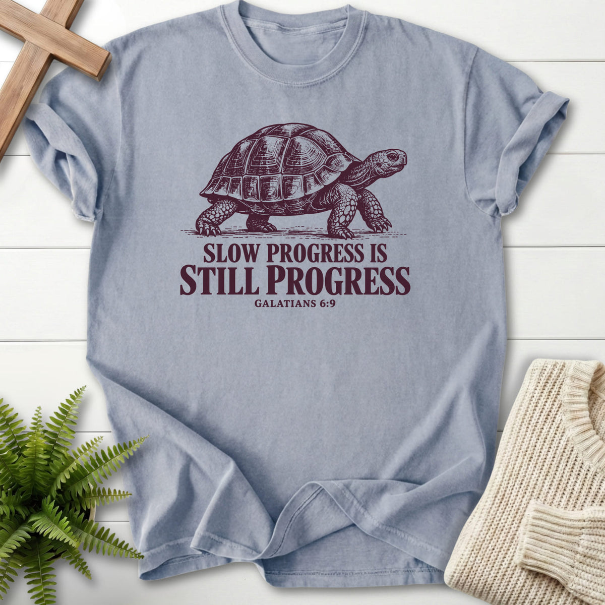 Flat lay of a Granite Christian graphic tee featuring "Slow Progress Is Still Progress T-Shirt" Galatians 6:9.