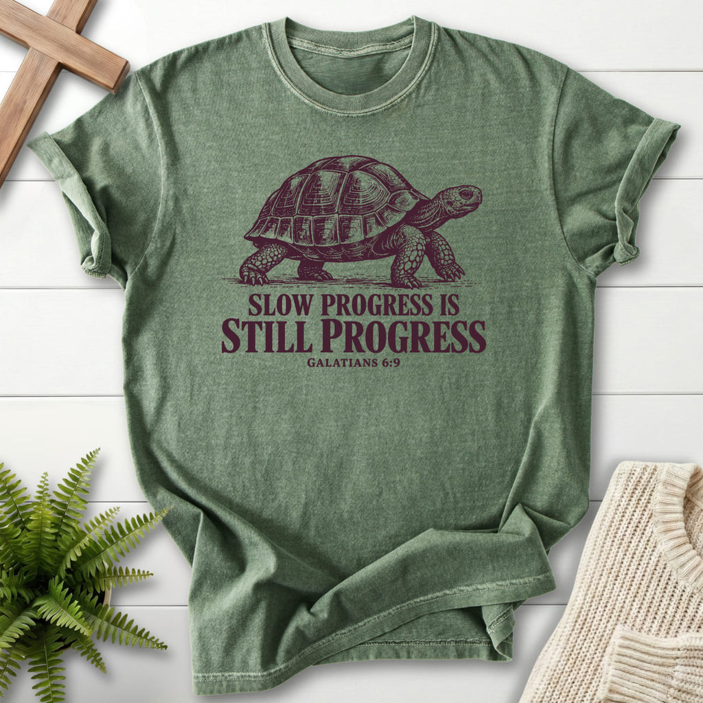 Moss color option for the Slow Progress Is Still Progress faith-inspired shirt with "Slow Progress Is Still Progress T-Shirt" Galatians 6:9.