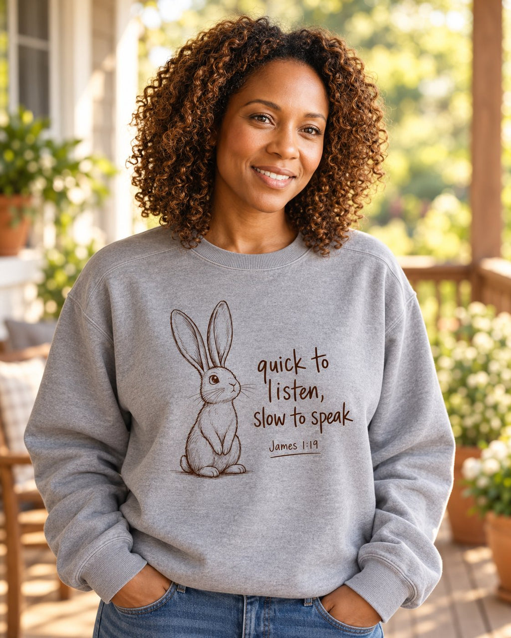Quick to Listen Slow to Speak Rabbit James 1:19, Grey women's Christian sweatshirt, lifestyle photo in sunny porch, rabbit with quick to listen slow to speak lettering, She Wears Faith