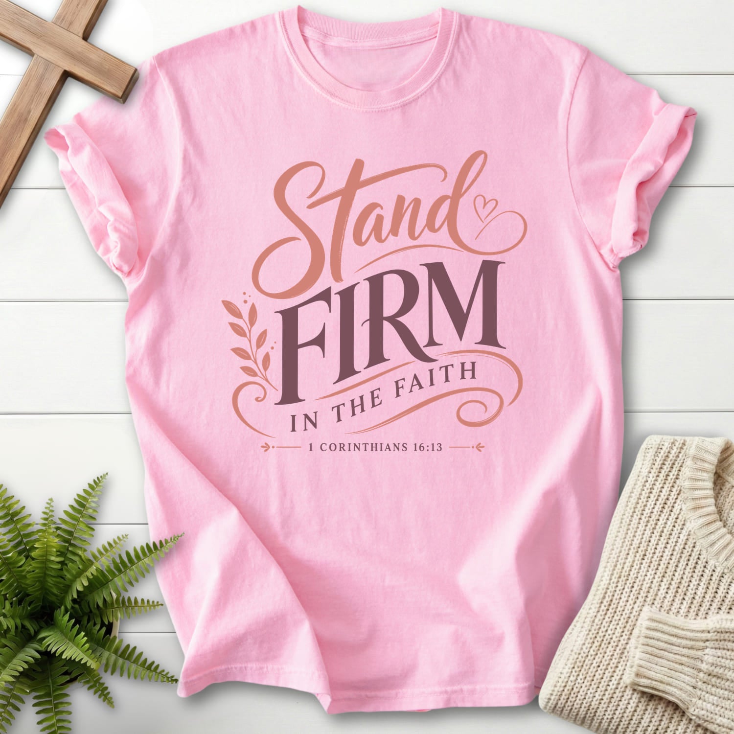 Flatlay of a Blossom Comfort Colors 1717 Bible verse tee with script typography with "Stand Firm in the Faith T-Shirt" 1 Corinthians 16:13.