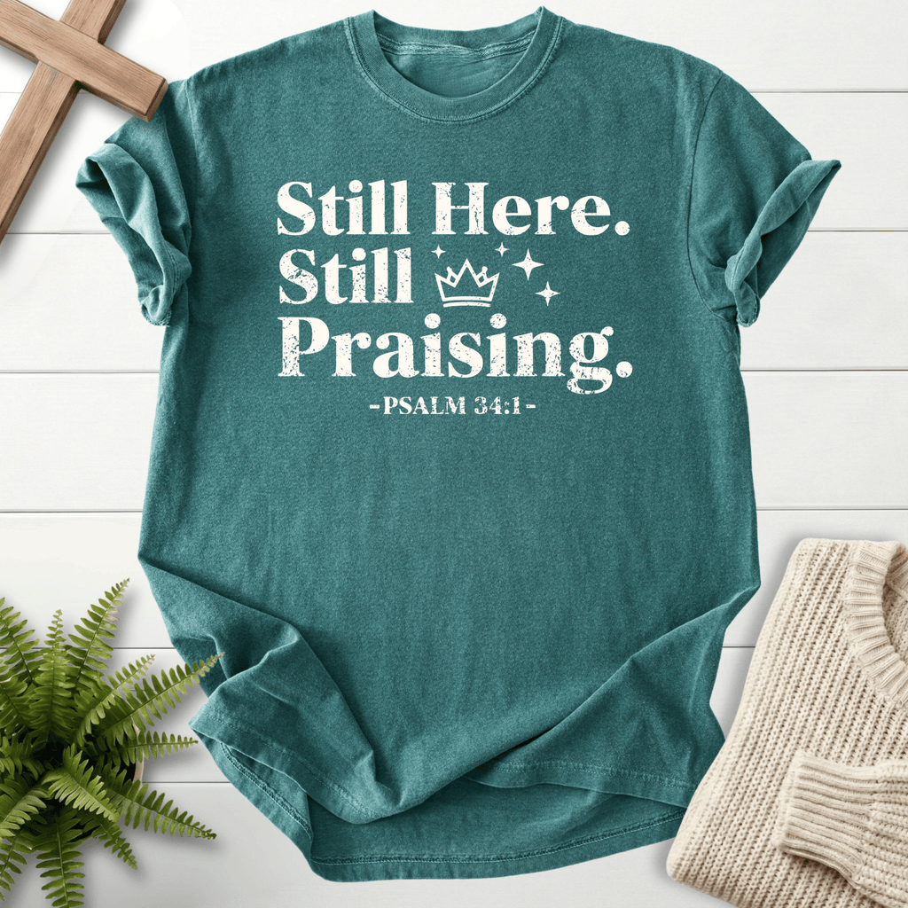 Blue Spruce Christian t-shirt for women with distressed Still Here, Still Praising lettering and sparkle stars, inspired by Psalm 34:1.