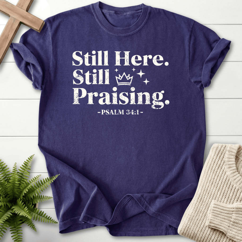 Grape Christian t-shirt for women with bold Still Here, Still Praising lettering and a clean vintage look, inspired by Psalm 34:1.
