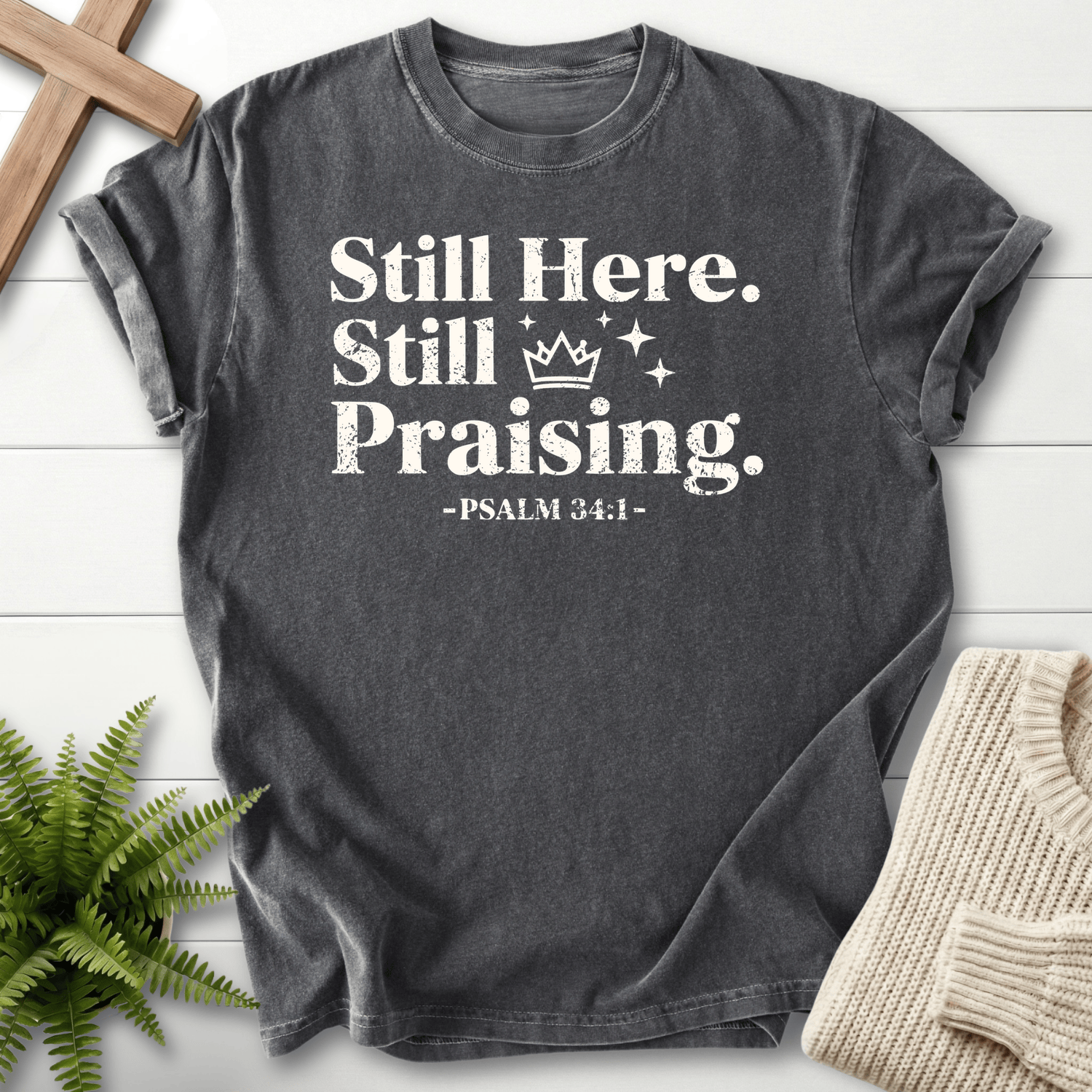 Pepper faith-based tee with grunge Still Here, Still Praising text, a crown graphic, and Psalm 34:1.