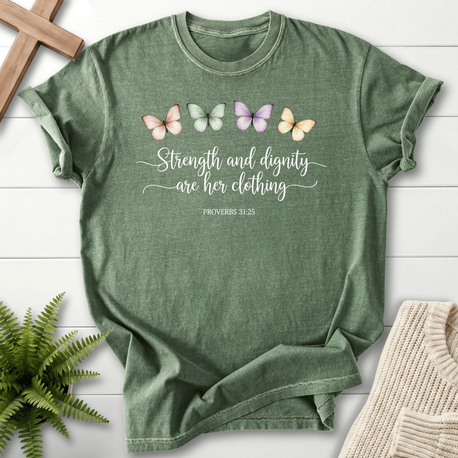 Moss Bible verse tee with pastel butterflies and Strength and Dignity Are Her Clothing lettering, Proverbs 31:25.