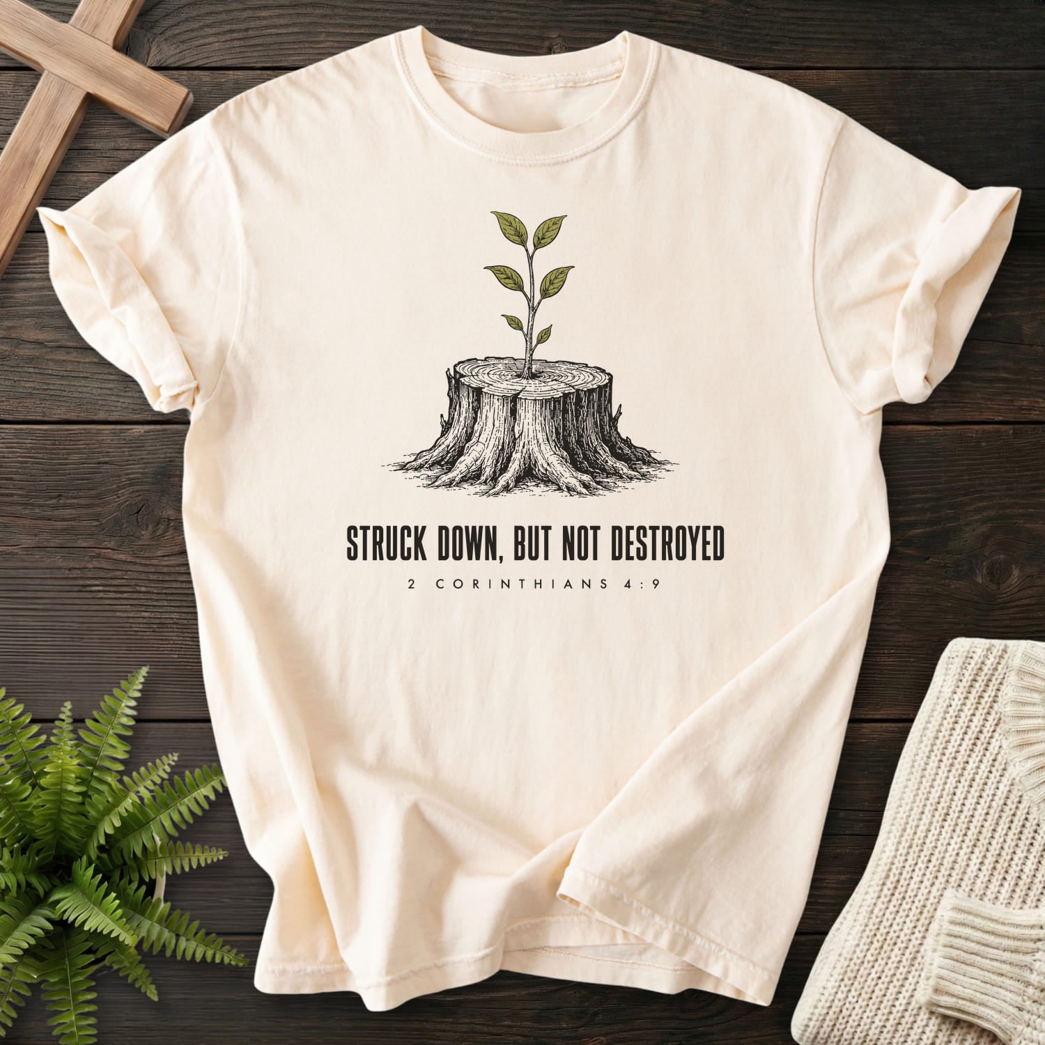 Flat lay of an Ivory Comfort Colors 1717 Christian graphic tee featuring "Struck Down But Not Destroyed T-Shirt" design.