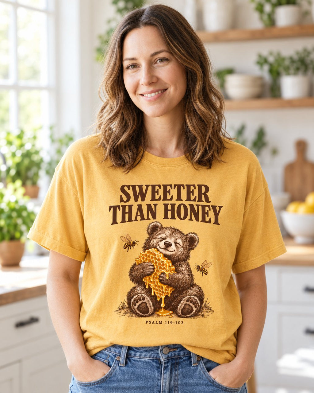 Sweeter Than Honey Bear, Mustard women's Christian tee, lifestyle photo in morning kitchen setting, bear hugging honeycomb with SWEETER THAN HONEY, Psalm 119:103, She Wears Faith