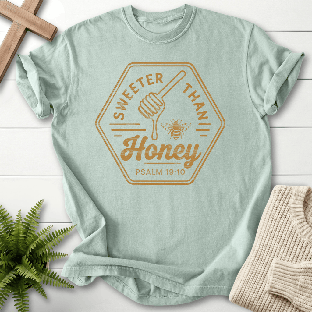 Bay faith-based tee with a tonal Sweeter Than Honey badge, honey dipper, and bee, inspired by Psalm 19:10.