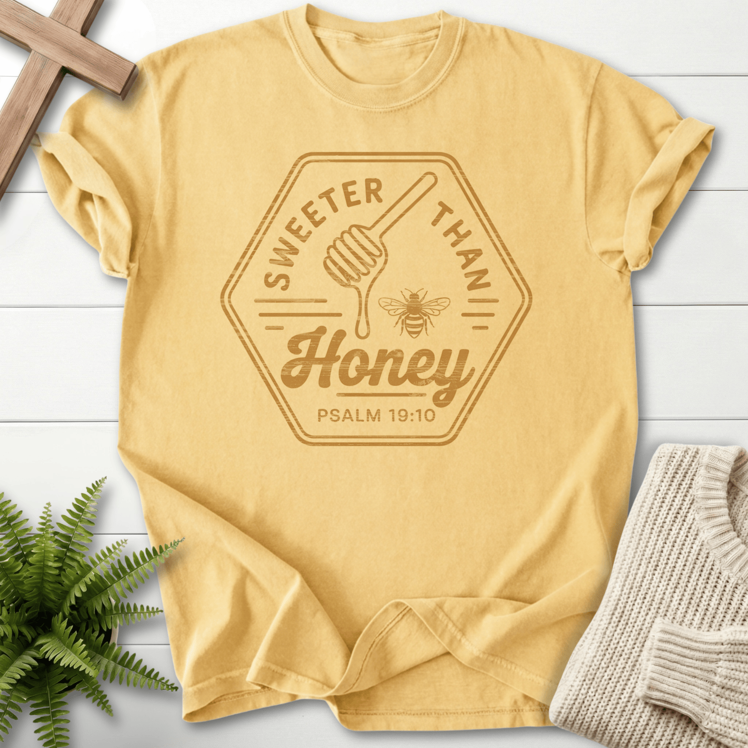 Butter Christian t-shirt for women with a vintage hexagon badge, honey dipper, and bee graphic, inspired by Psalm 19:10.