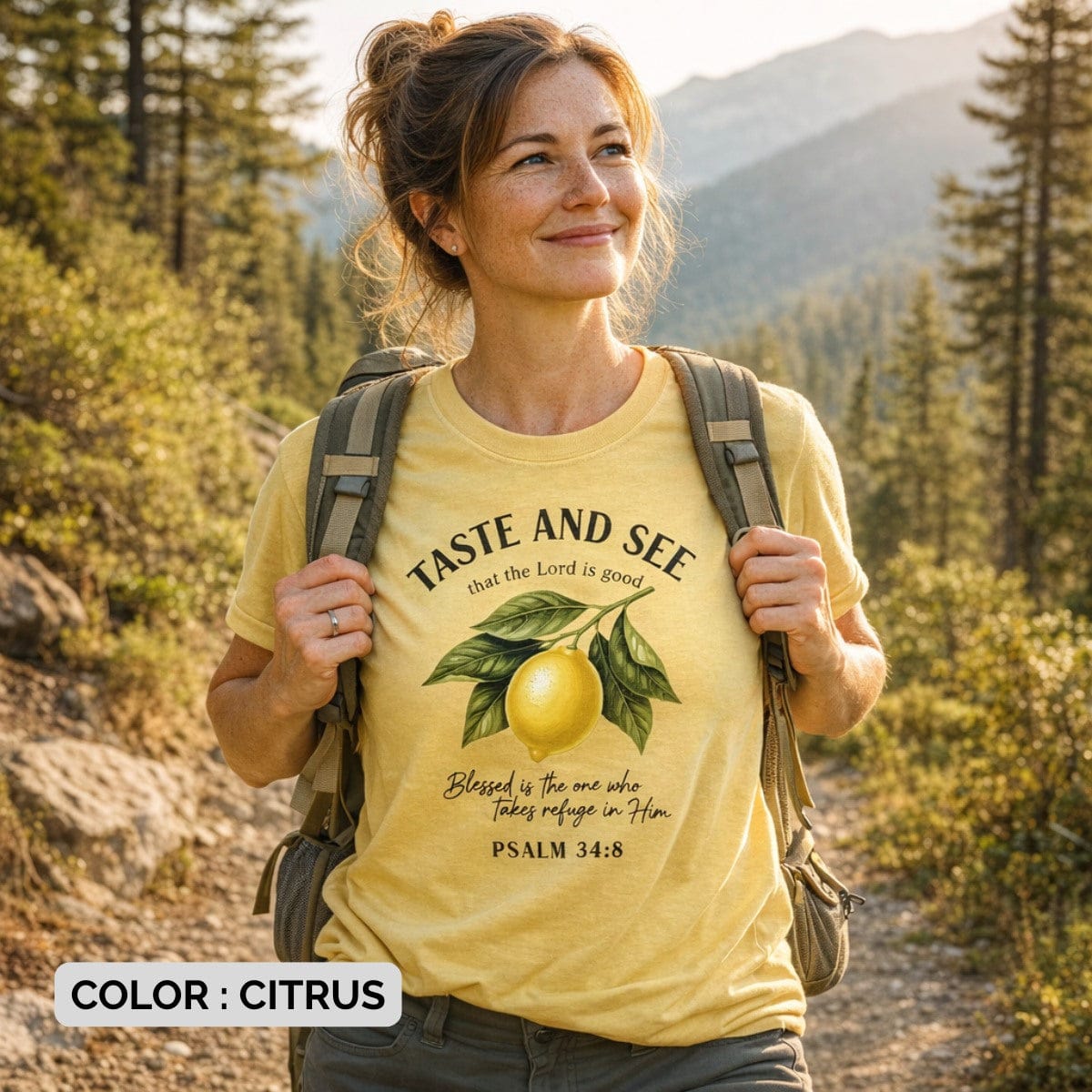 Happy woman hiking outdoors wearing a Citrus Yellow Comfort Colors 1717 tshirt with a lemon scripture design. Lifestyle photography of a Christian women tee in nature, showcasing versatile US faith wear for active believers.