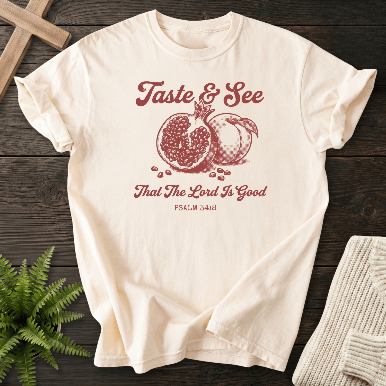 Ivory faith-based tee with the Taste and See That the Lord Is Good pomegranate design, inspired by Psalm 34:8.