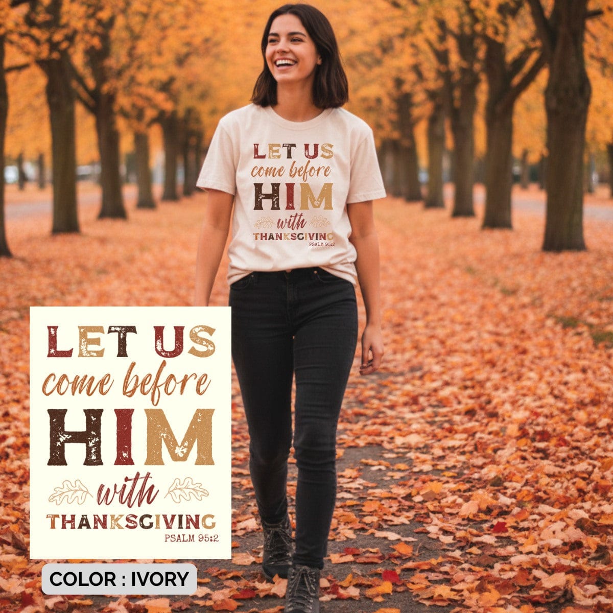 Smiling woman walking through fall leaves wearing an ivory Christian t-shirt that says “Let Us Come Before Him With Thanksgiving, Psalm 95:2.” Autumn trees background, faith-based Thanksgiving shirt, Comfort Colors style, Christian apparel for women.
