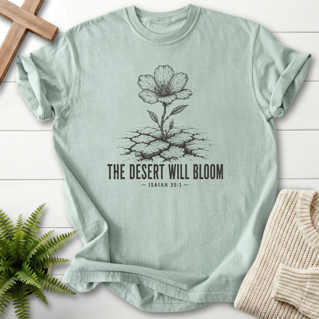 Flat lay of a Bay faith-inspired shirt featuring flower artwork with "The Desert Will Bloom T-Shirt".