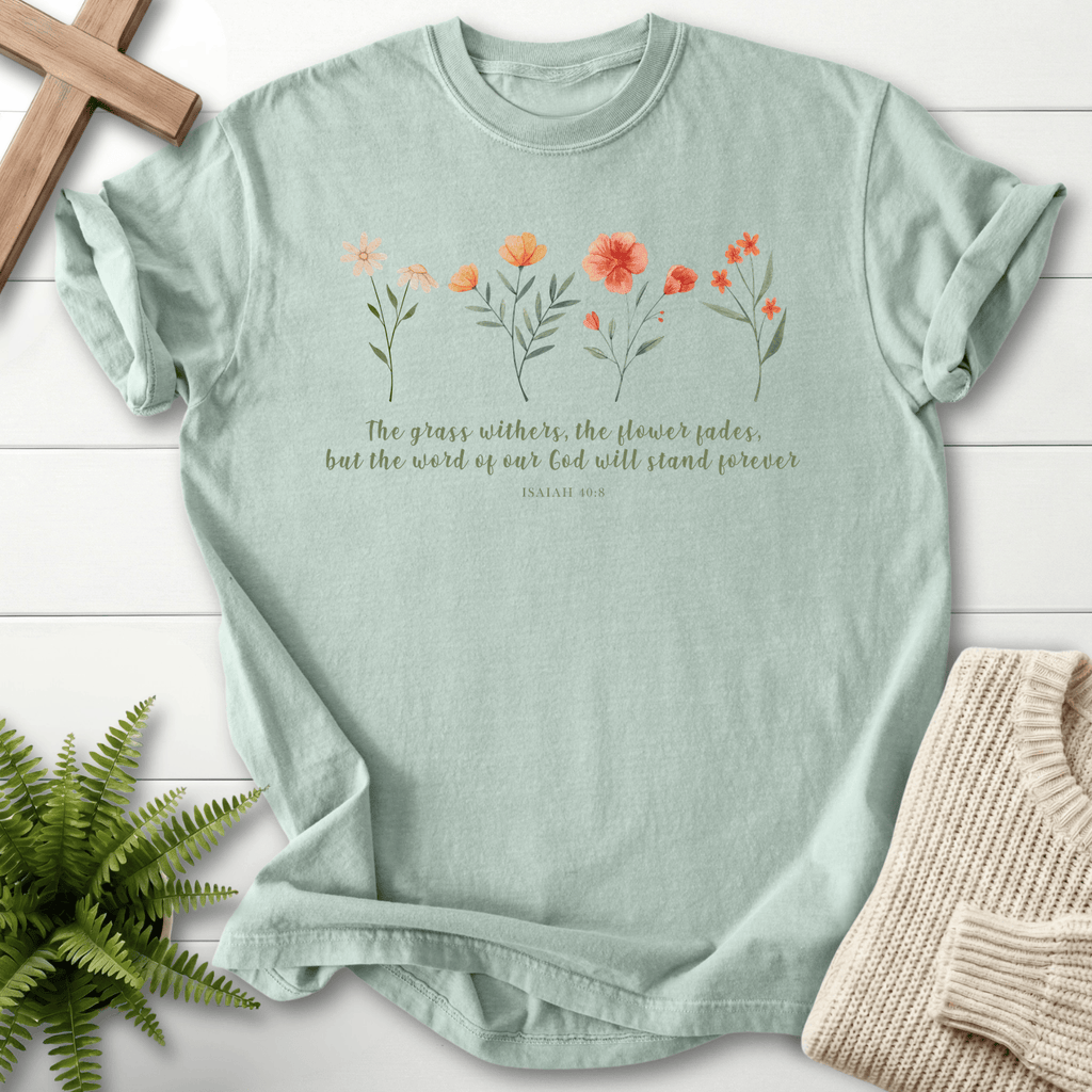 Bay faith-based tee with pastel wildflower illustration and The Word of God Will Stand Forever script, Comfort Colors 1717, inspired by Isaiah 40:8.