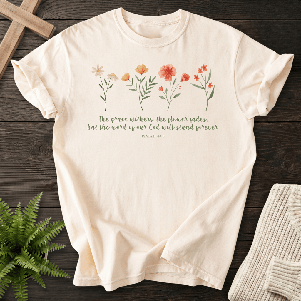Ivory Christian t-shirt for women with a watercolor wildflower row and The Grass Withers, The Flower Fades text, inspired by Isaiah 40:8.