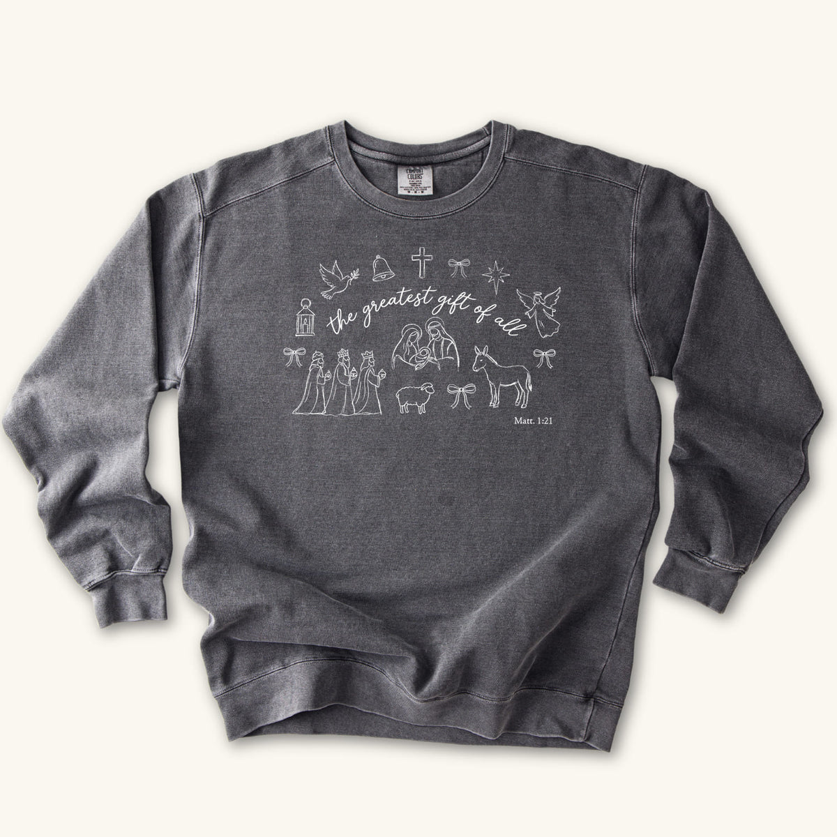 Pepper Christian Christmas sweatshirt with the greatest gift of all script and line art of the holy family, wise men, a donkey, a lamb, an angel, a dove, a cross and Matthew 1:21.