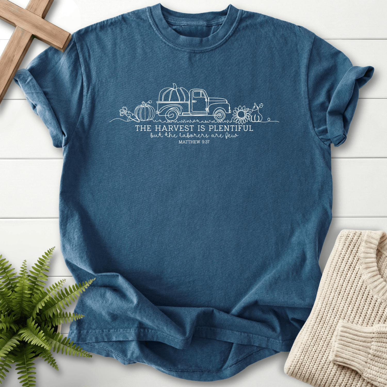 Midnight blue Bible verse tee with a line-art harvest truck and 'The Harvest Is Plentiful', inspired by Matthew 9:37.