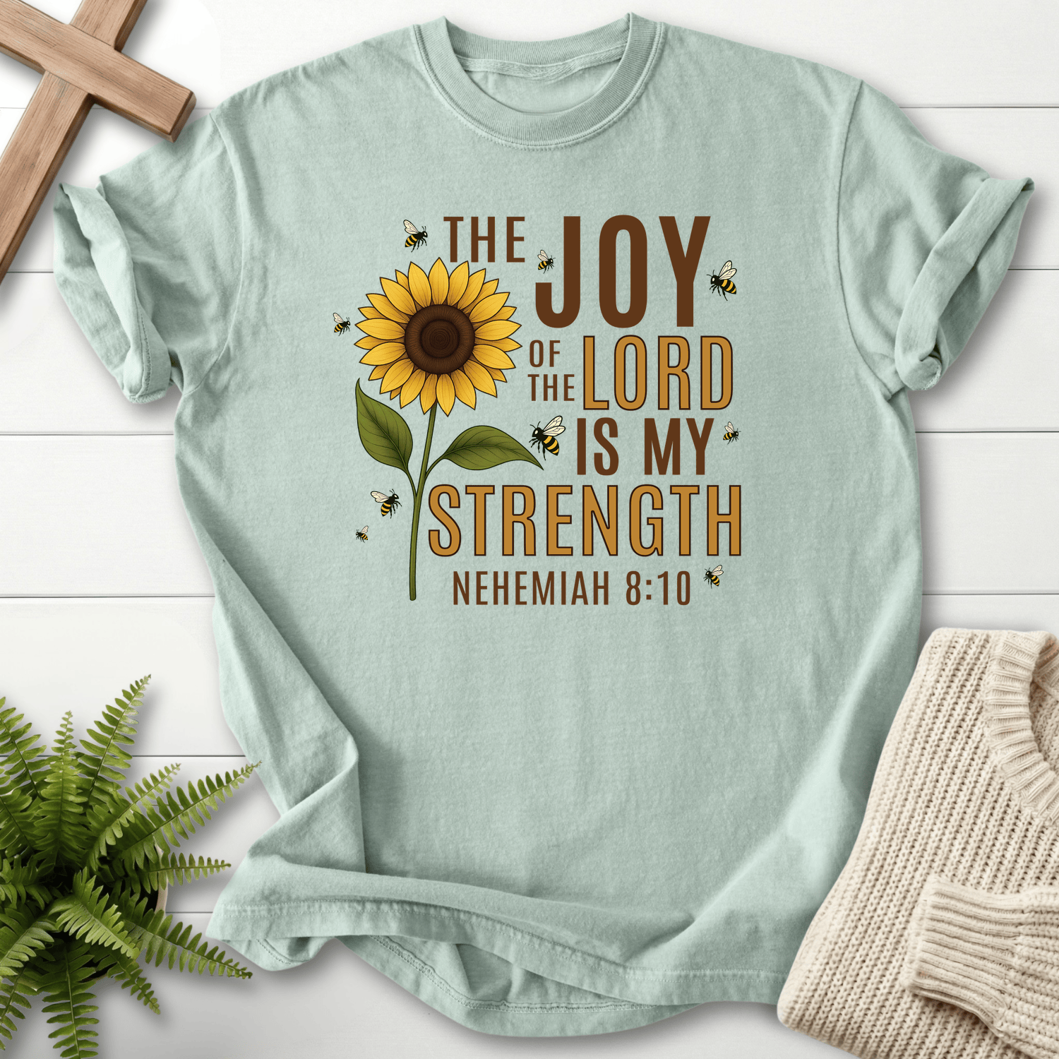 Bay Christian t-shirt for women with a tall sunflower and buzzing bees and Joy of the Lord Is My Strength text, inspired by Nehemiah 8:10.