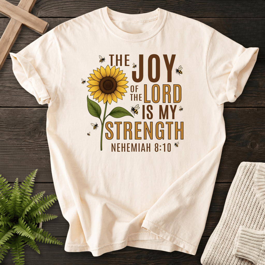 Ivory faith-based tee with sunflower illustration and bee accents and The Joy of the Lord Is My Strength text, inspired by Nehemiah 8:10.