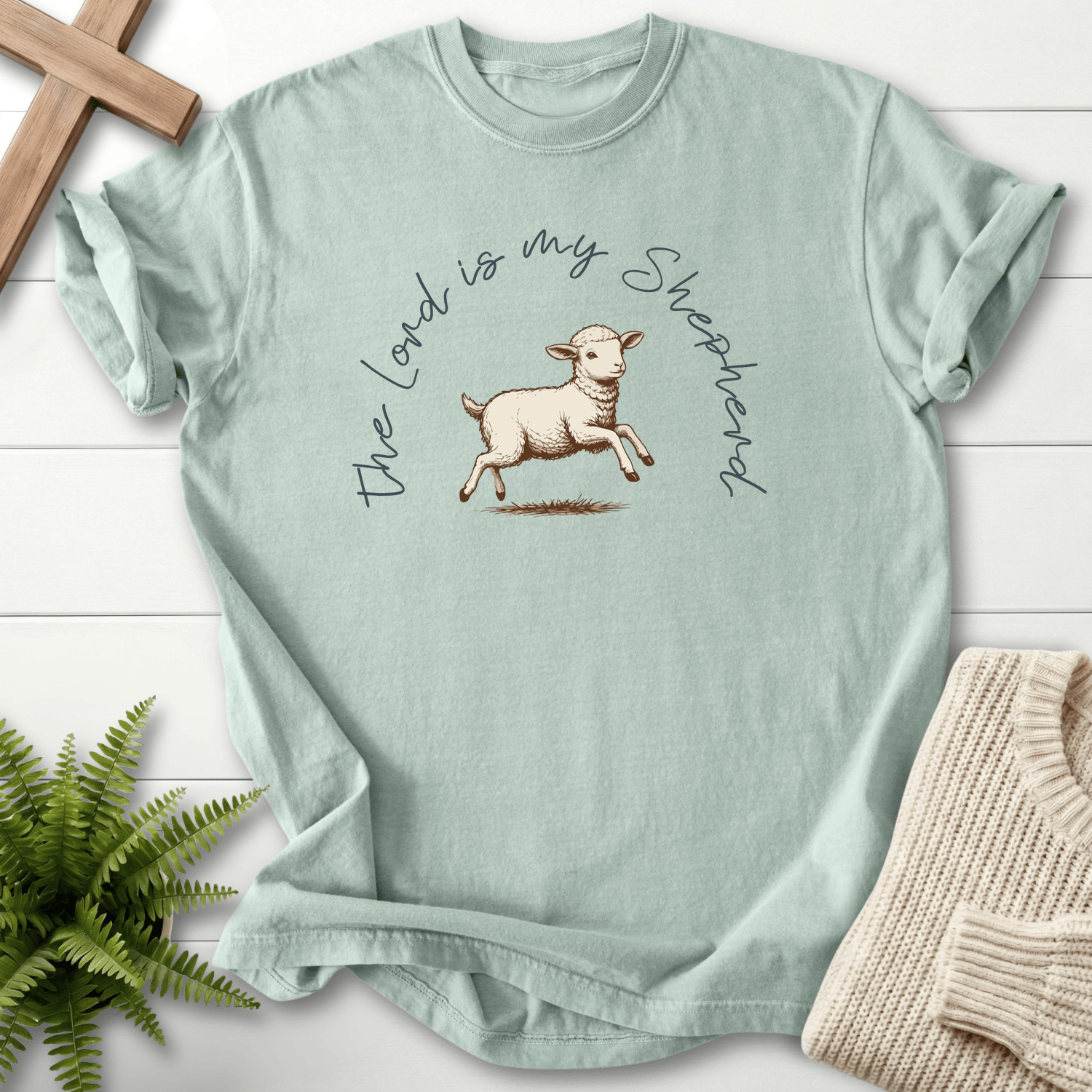Bay Bible verse tee with The Lord Is My Shepherd cursive lettering and an ink-sketch lamb illustration, inspired by Psalm 23.