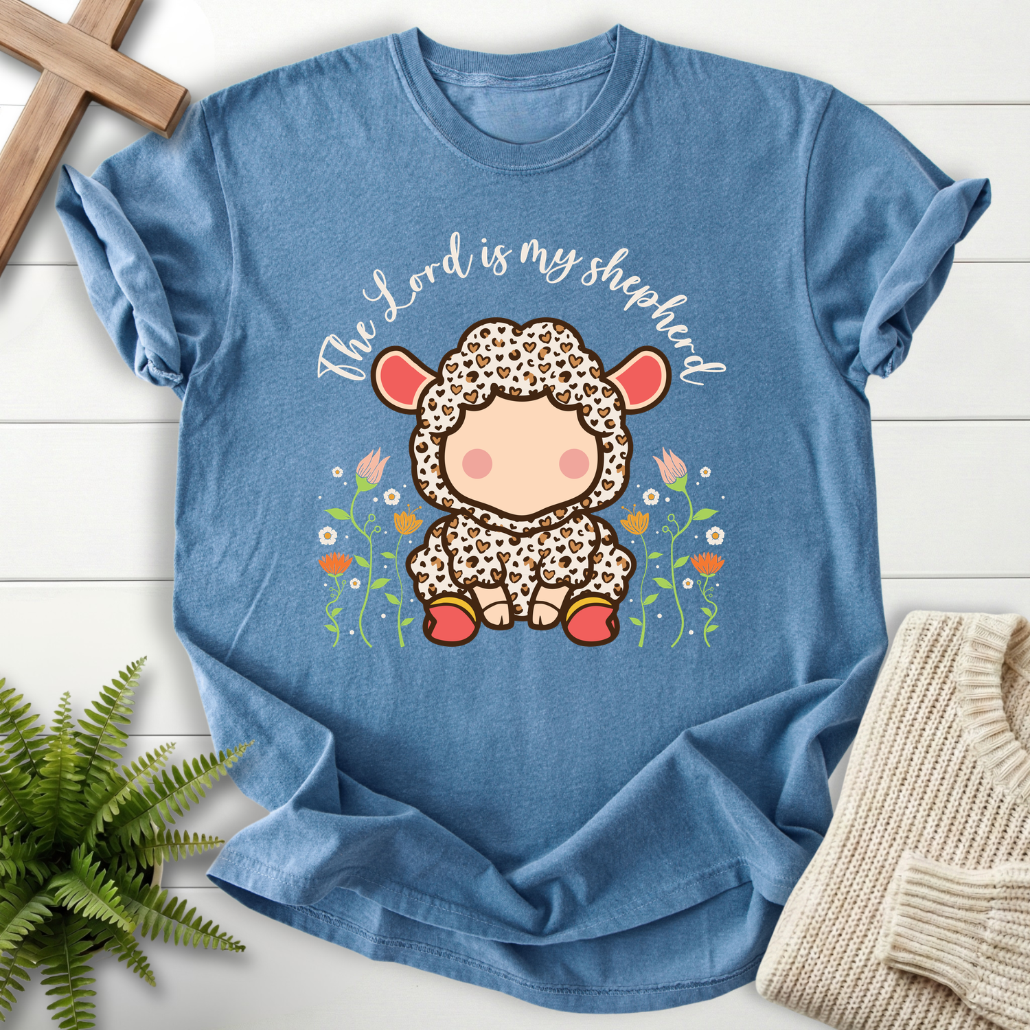 Blue Jean faith-based tee with a cute spotted lamb illustration and The Lord Is My Shepherd cursive script, inspired by Psalm 23.