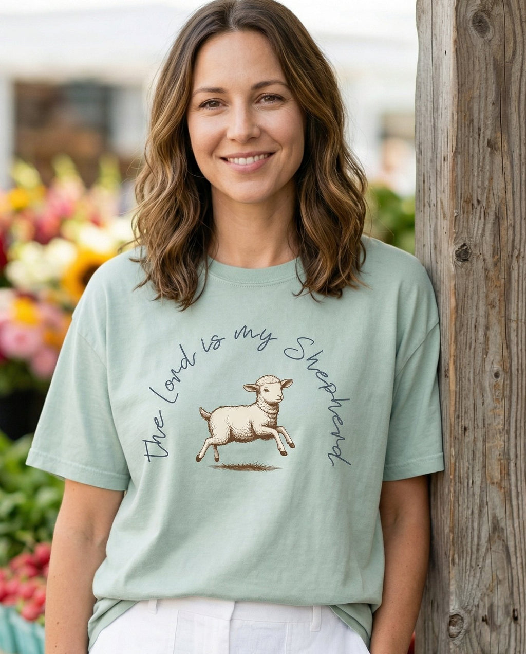 The Lord is My Shepherd – Bay women's Christian tee, lifestyle photo in farmers market – Hand-drawn vintage sketch of a leaping lamb with 'The Lord is my Sheph – Psalm 23 – She Wears Faith