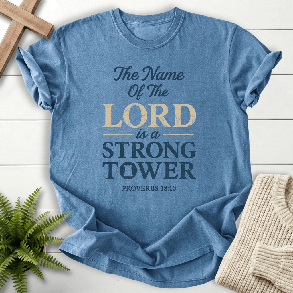 Blue Jean Christian t-shirt for women with bold distressed The Name of the Lord Is a Strong Tower design, inspired by Proverbs 18:10.