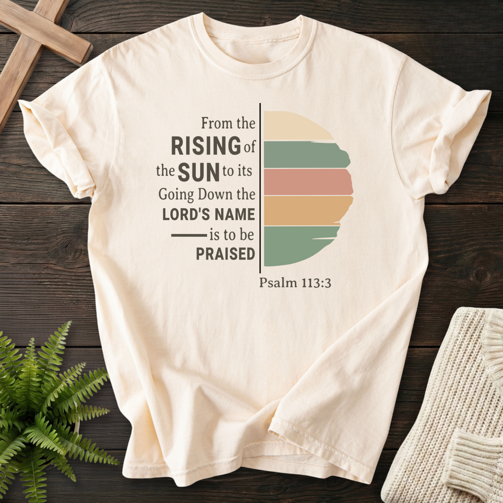 Ivory women's faith t-shirt with a retro half-sun in earth tones and 'From the Rising of the Sun', Psalm 113:3.