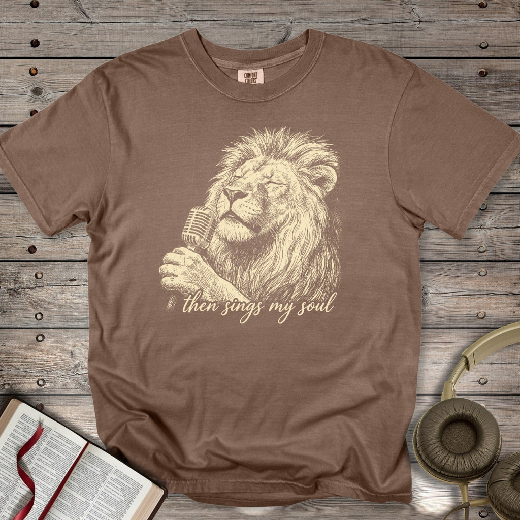 Espresso Brown Comfort Colors 1717 tshirt with a cream-colored lion graphic and worship lyrics. Vintage-inspired Christian women tee styled with worship accessories, ideal for US faith wear collections.