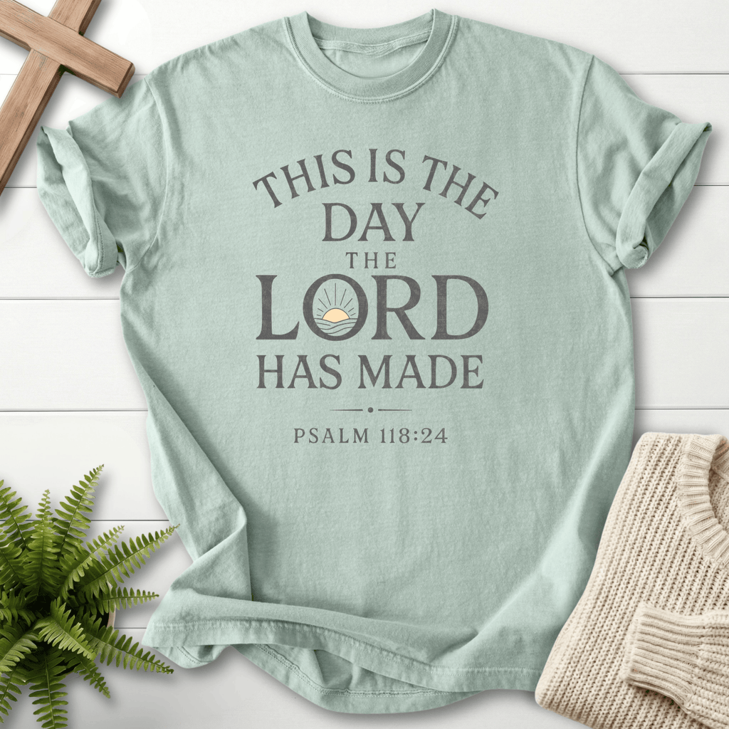 Bay faith-based tee with bold stacked This Is the Day the Lord Has Made lettering and a sunrise motif, Comfort Colors 1717, inspired by Psalm 118:24.