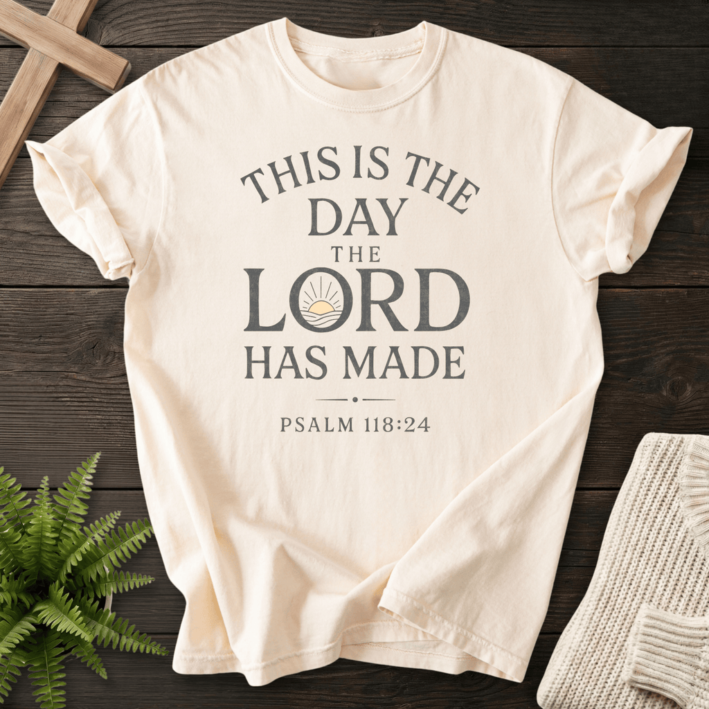 Ivory Christian t-shirt for women with clean bold stacked lettering and a sunrise icon, inspired by Psalm 118:24.