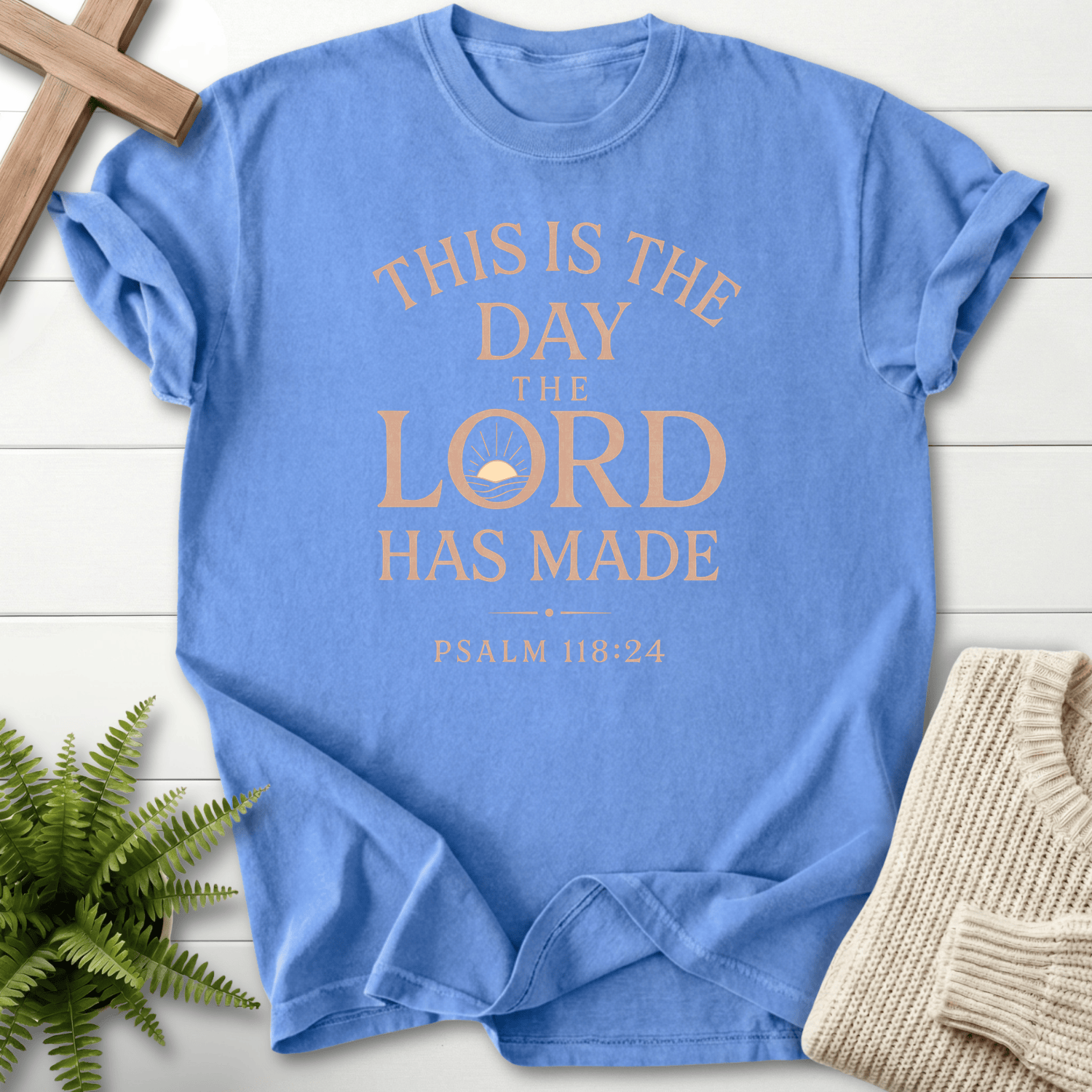 Mystic Blue faith-based tee with bold sunrise motif and stacked This Is the Day the Lord Has Made text, inspired by Psalm 118:24.