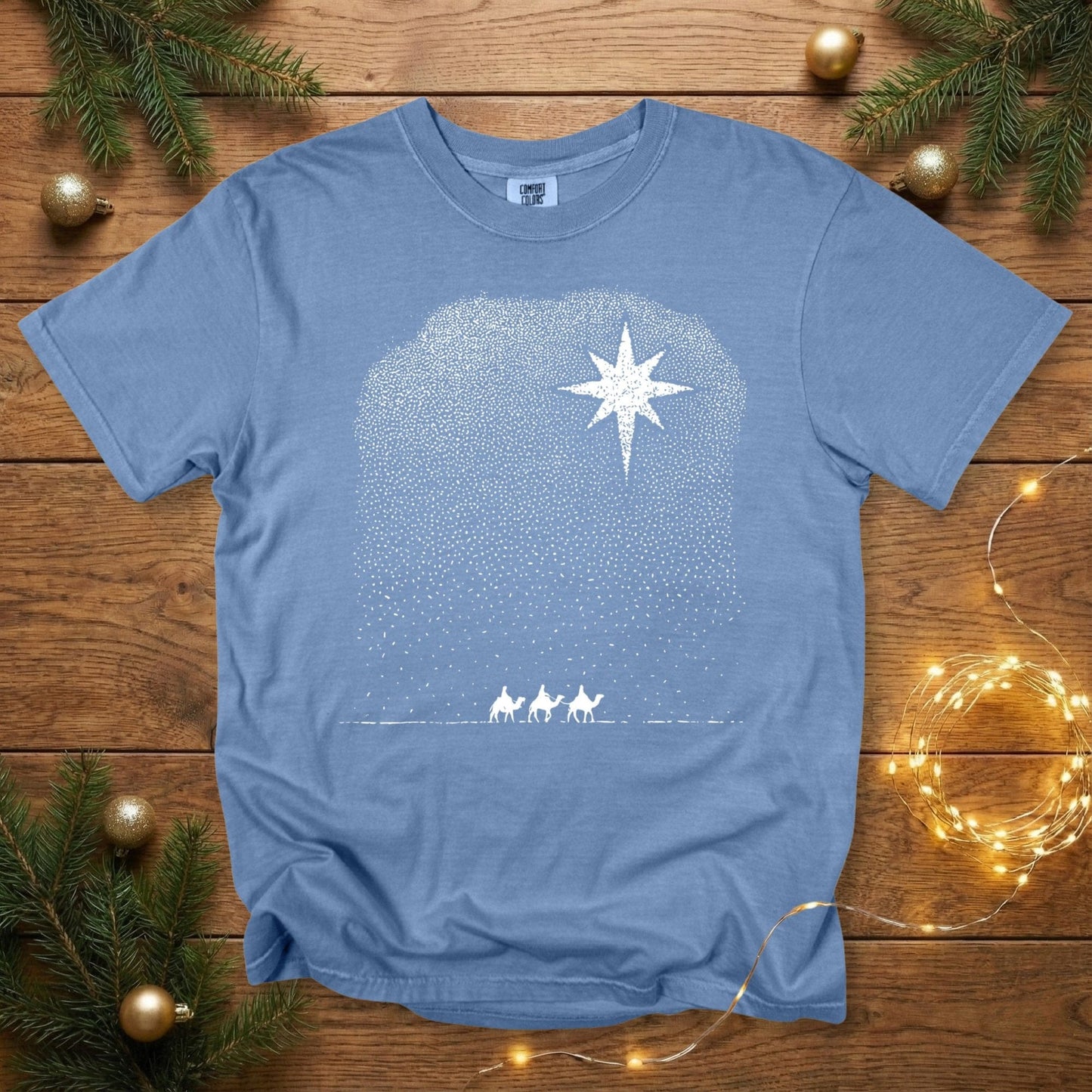 Comfort Colors 1717 blue jean Christian women tee with a white dotted illustration of the Star of Bethlehem and the Three Wise Men traveling beneath it. A festive, minimalist Christmas faith shirt ideal for US faith wear and scripture-inspired holiday apparel.