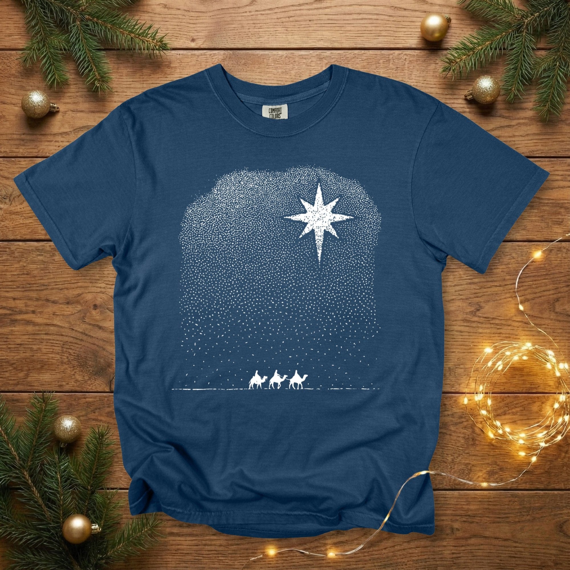 Comfort Colors 1717 midnight navy Christian women’s T-shirt showcasing a starry-night dotted design with the Star of Bethlehem and the silhouettes of the Three Wise Men. A modern, minimalist Christmas Christian tee great for US faith wear and holiday season styling.