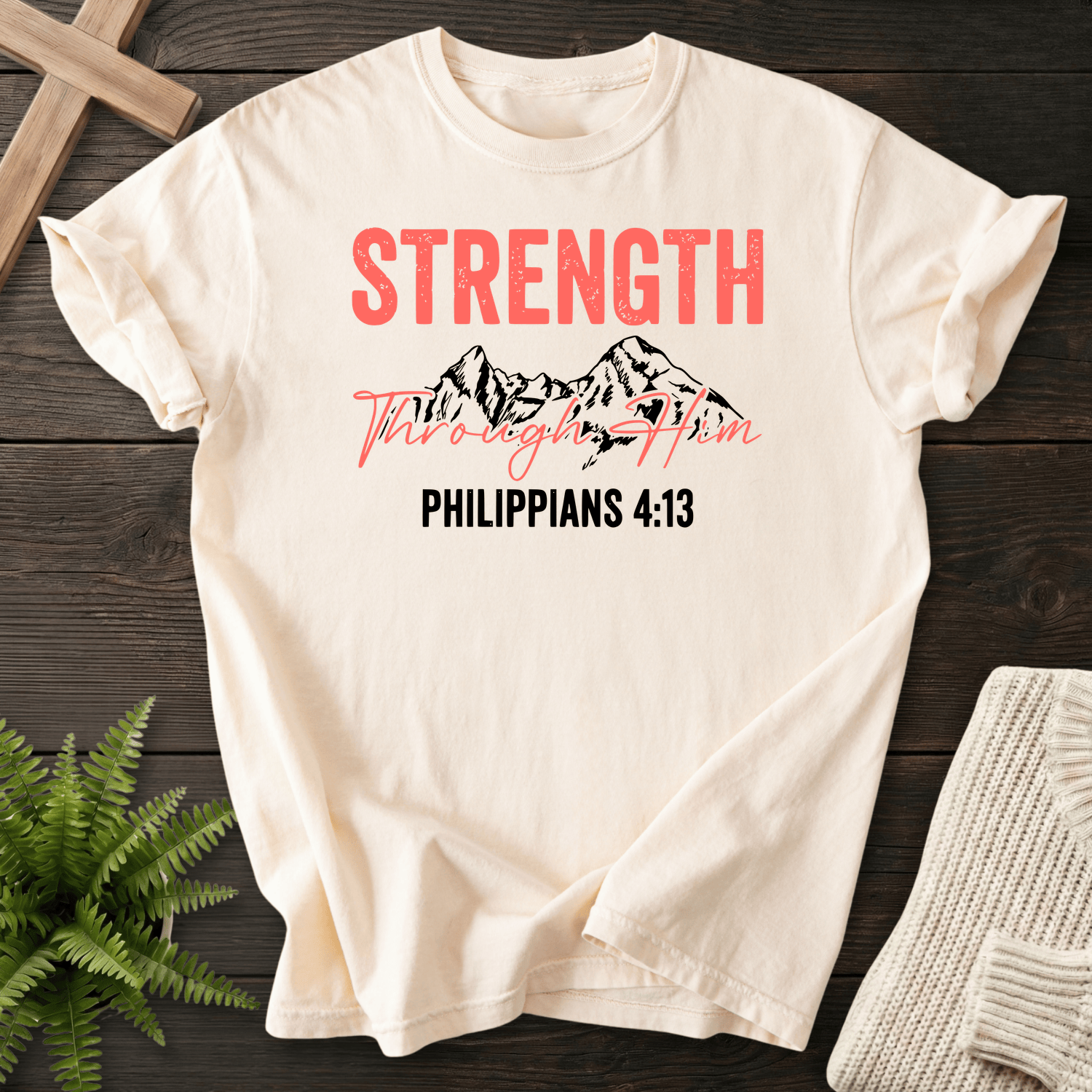 Ivory Christian t-shirt for women with Strength Through Him mountain artwork, by She Wears Faith, inspired by Philippians 4:13.