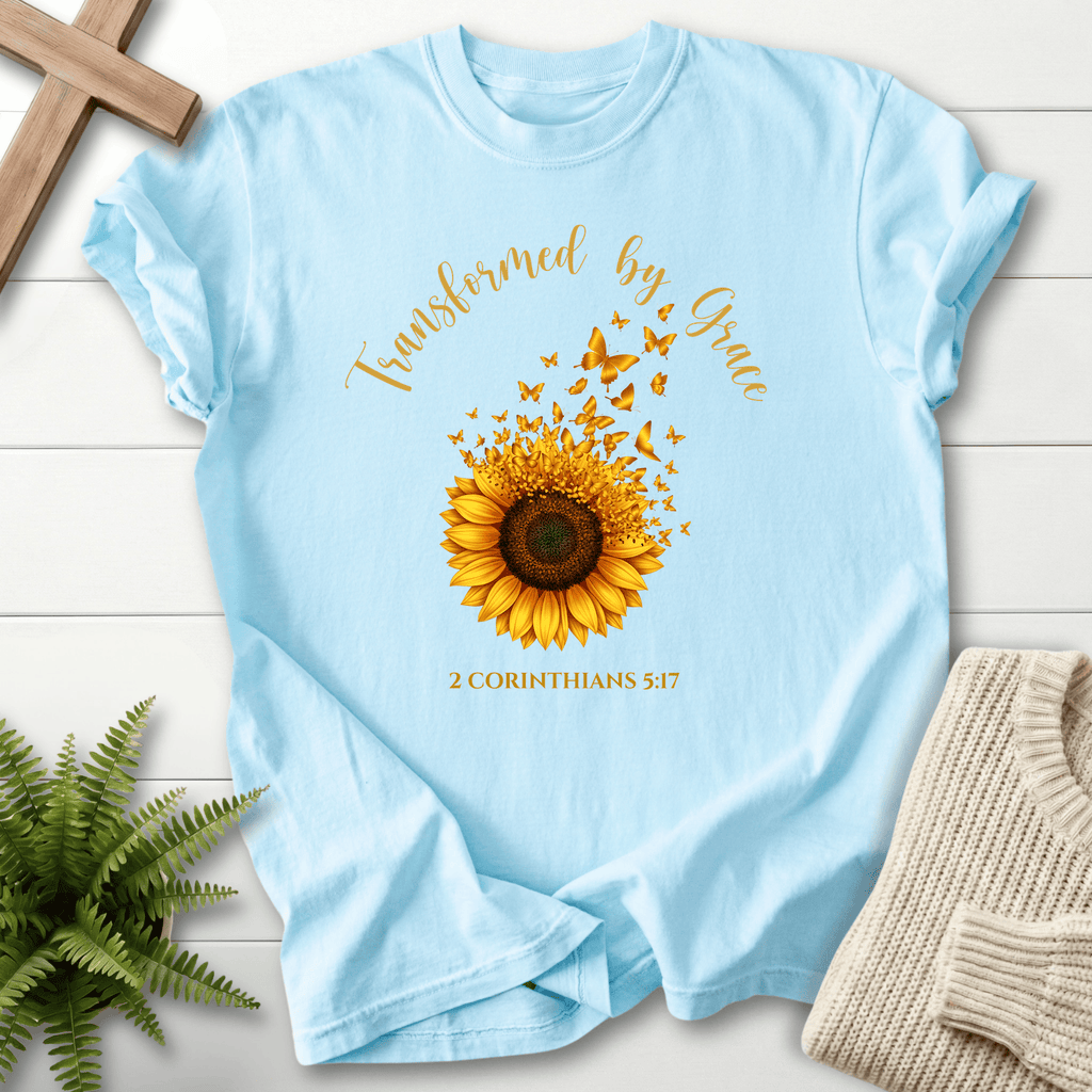 Chambray Christian t-shirt for women with a golden sunflower and rising butterflies, inspired by 2 Corinthians 5:17.