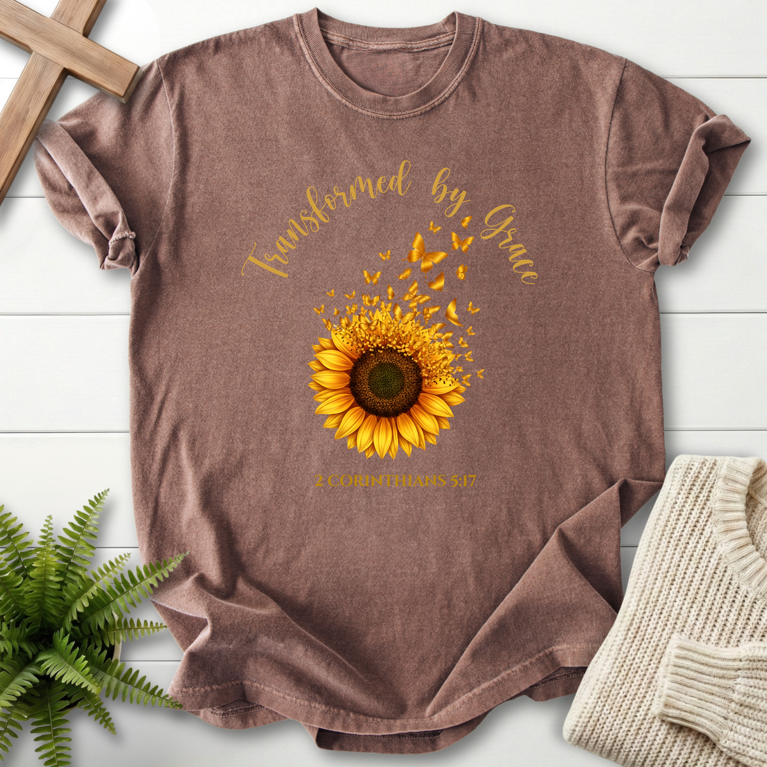 Espresso Scripture shirt with a sunflower releasing golden butterflies, inspired by 2 Corinthians 5:17.
