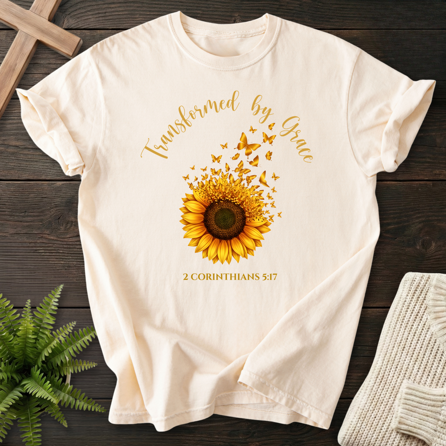 Ivory Christian t-shirt for women with a sunflower and butterflies motif, inspired by 2 Corinthians 5:17.