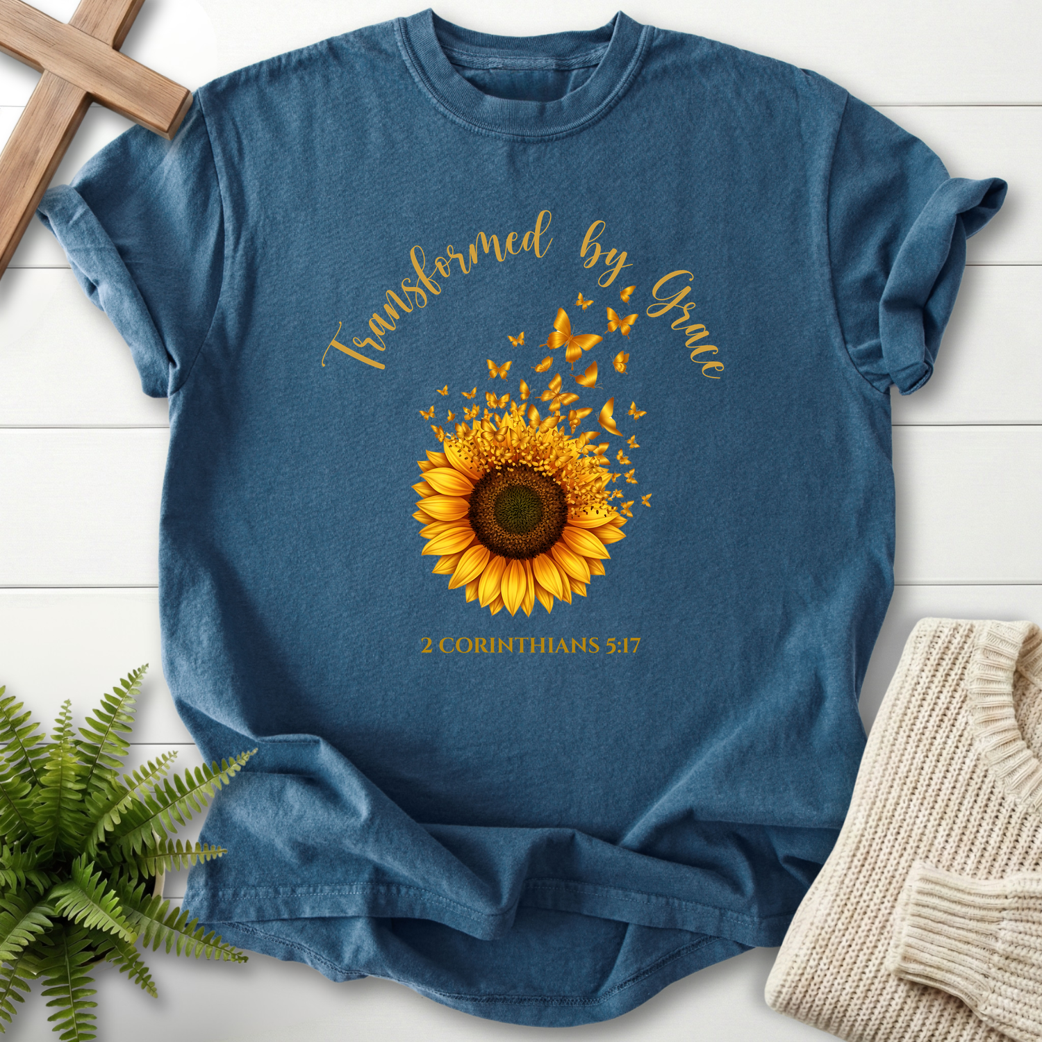 Midnight faith-based tee with golden sunflower and butterfly transformation design, Comfort Colors 1717, inspired by 2 Corinthians 5:17.