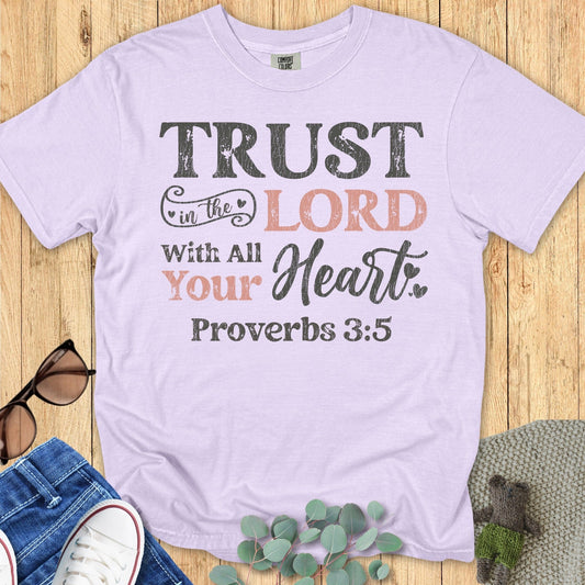 Comfort Colors 1717 orchid “Trust in the Lord with all your heart – Proverbs 3:5” t-shirt featuring warm blush and black distressed lettering. A feminine and inspiring women’s scripture tee — faith-based apparel for women and thoughtful Christian gift idea for moms.