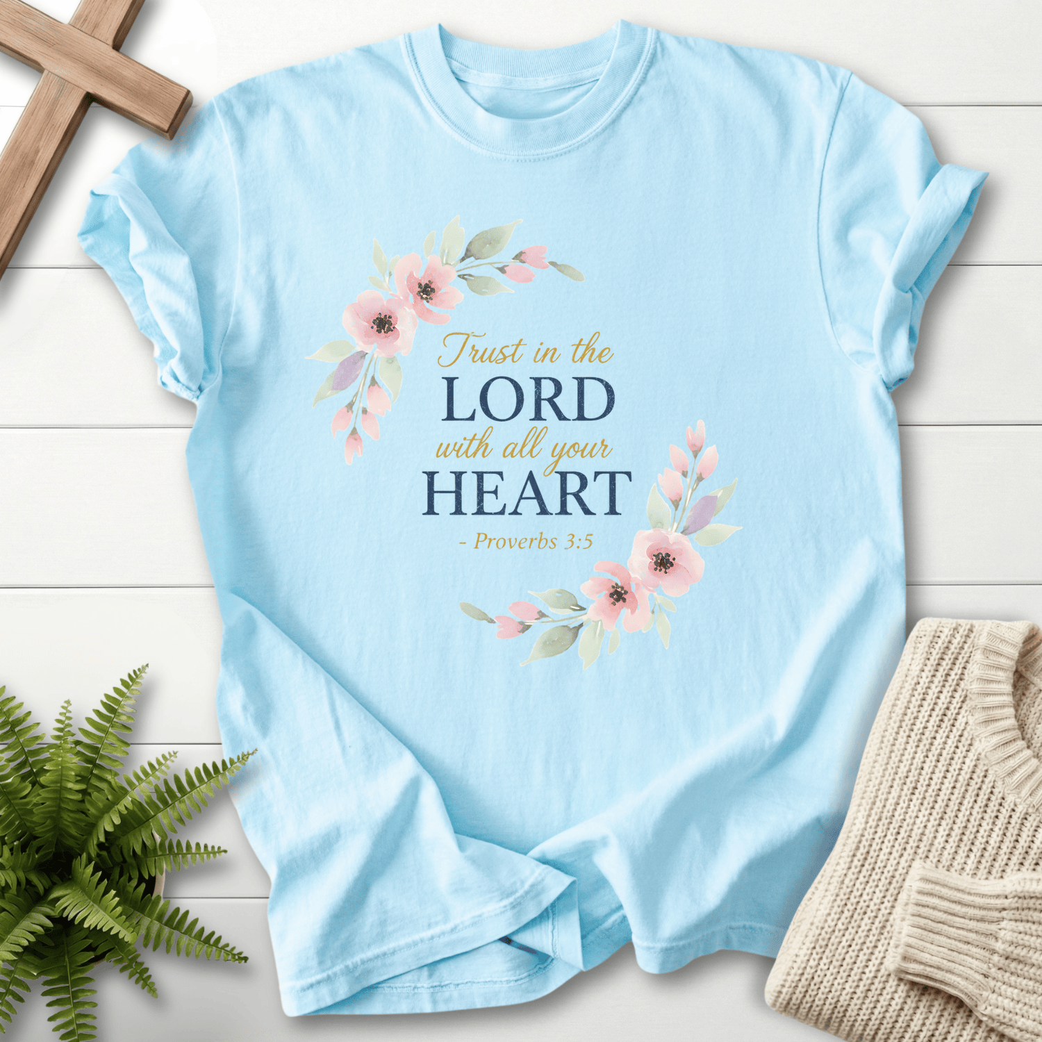 Chambray Christian t-shirt for women with a pink flower and leaf wreath and Trust in the Lord With All Your Heart text, by She Wears Faith.